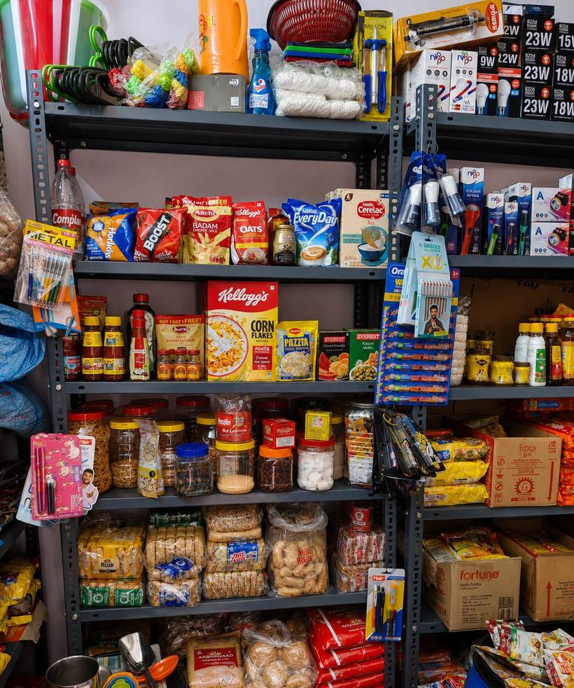 General goods shelf at Eden Departmental Stores with health drinks, cereals, cleaning supplies and bakery items