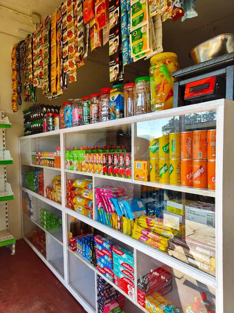 Shelf display of beverages, biscuits and toothpaste at Eden Departmental Stores